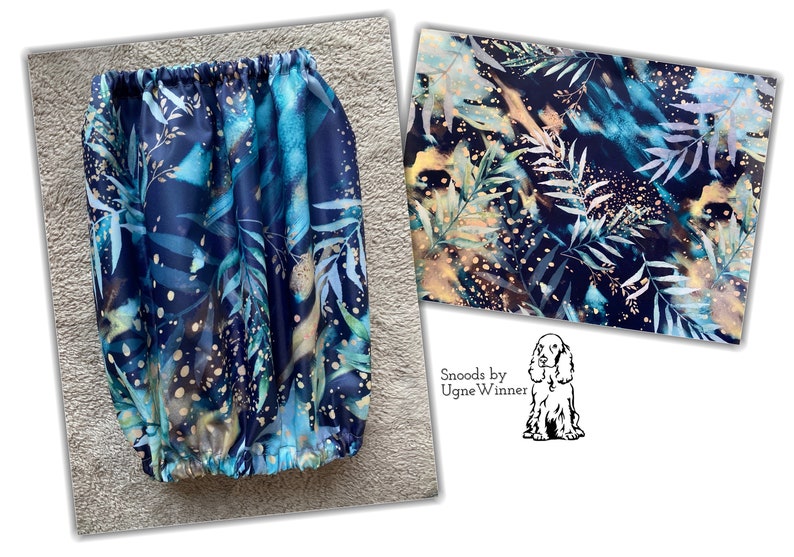 May include: A blue and green fabric with a gold leaf pattern. The fabric is gathered at the top and bottom, creating a tube shape. The fabric is labelled "Snoods by Ugne Winner".