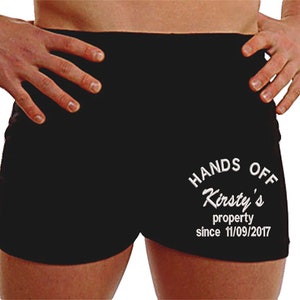 May include: Black athletic shorts with the text "Hands Off Kirsty's property since 11/09/2017" in white.
