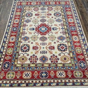 Afgan kazak Pakistani kazak  tribal rug hand knotted rug  transitional rug green and red  kazak size 5&#39;2&quot;×7&#39;