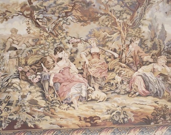 May include: A tapestry depicting a pastoral scene with five figures in a wooded setting. The figures are dressed in 18th-century clothing and are engaged in various activities, such as playing music and tending to sheep. The tapestry is woven in a variety of colors, including browns, greens, and blues.