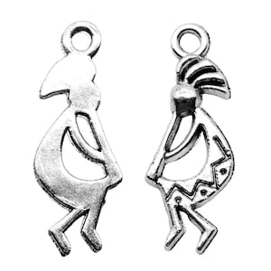 May include: Two silver charm pendants in the shape of Kokopelli, a Native American flute player, with a traditional design. The charms have a loop at the top for attaching to a necklace or bracelet.