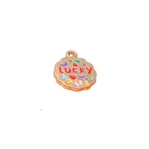 May include: Gold charm with a colorful enamel design. The charm is shaped like a cloud and has the word "LUCKY" written in red letters.