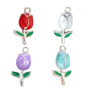 May include: Four enamel flower charms in different colors: red, white, purple, and blue. Each charm features a silver tulip with green leaves and a loop for attaching to jewelry.