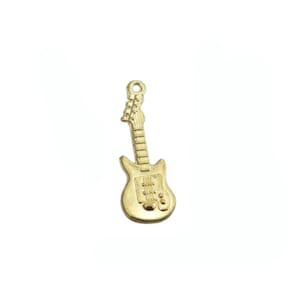 May include: A gold-colored metal charm shaped like an electric guitar. The charm has a detailed design with a body, neck, and strings.