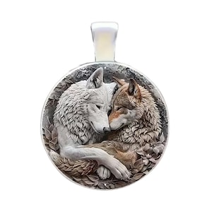 May include: A round pendant featuring two wolves in a tender embrace. One wolf is white, the other is brown, and they are surrounded by a floral design. The pendant has a silver-colored bail.