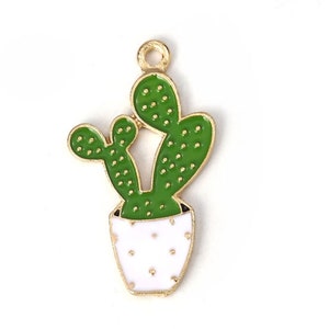 May include: Gold-tone metal charm featuring a green cactus with white polka dots in a white pot with gold polka dots.
