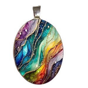 May include: Oval pendant with a vibrant, abstract design. The pendant features a spectrum of colors, including purple, blue, green, yellow, and red, with gold accents. The pendant has a silver-colored bail for attaching to a chain.