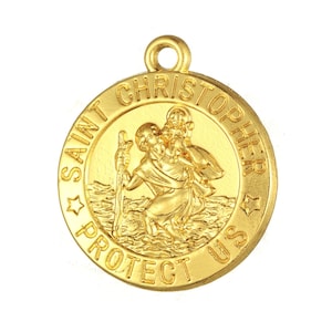 May include: Gold-colored metal pendant with a depiction of Saint Christopher carrying a child. The pendant has the words "Saint Christopher Protect Us" inscribed around the edge.