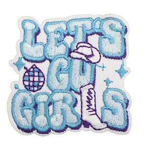 May include: Blue and purple embroidered patch with the text "Let's Go Girls" in a retro font. A disco ball and a boot with a cowboy hat are included in the design.