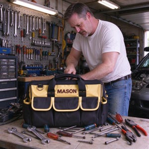 May include: A black and yellow tool bag with the name MASON printed in dark letters on the front. The bag features multiple exterior pockets, sturdy carrying handles, and a metal D-ring, designed for organizing and transporting various hand tools.