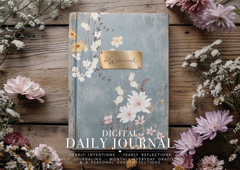 May include: A digital daily journal with a floral design on the cover. The cover is blue with white and pink flowers. The title "DIGITAL DAILY JOURNAL" is printed in black letters on the bottom of the cover. The text "YEARLY INTENTIONS - YEARLY REFLECTIONS DAILY JOURNALING - MONTHLY EVERYDAY GRATITUDE & 8 PERSONAL CUSTOM SECTIONS" is printed in smaller black letters below the title.