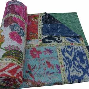 May include: A colorful patchwork quilt with a variety of floral and geometric patterns. The quilt is made of cotton and is hand-stitched. It is a traditional Indian kantha quilt.