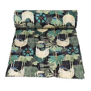May include: A black and green kantha quilt with a repeating pattern of trees, peacocks, and white structures. The quilt is hand-stitched and has a traditional Indian design.