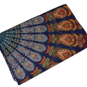 May include: A blue kantha quilt with a colorful paisley pattern. The quilt is made of cotton and is hand-stitched.
