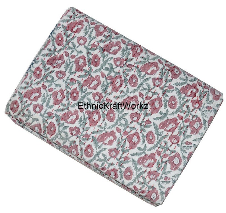May include: A white cotton fabric with a pink and green floral print. The fabric has a subtle striped pattern and the text "EthnicKraftWorkz" is visible in the center.