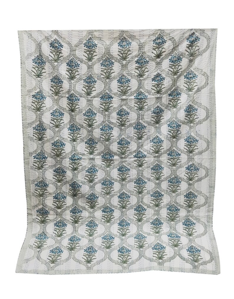May include: A white cotton quilt with a repeating pattern of blue and green floral designs. The quilt has a traditional Indian style.