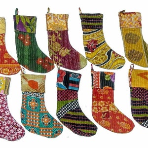 May include: Ten colorful patchwork Christmas stockings with a variety of patterns and colors, including red, green, yellow, blue, and black.