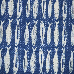 May include: A blue fabric with a white repeating pattern of fish. The fish are all facing the same direction and have a simple design.