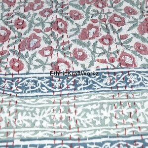 May include: A white cotton quilt with a floral pattern in shades of pink and green. The quilt has a blue and white border with a floral design. The text "EthnicKraftWorkz" is visible in the image.