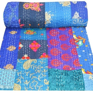 May include: A patchwork quilt with a blue background and colorful floral patterns. The quilt is made of various fabrics and is hand-stitched.