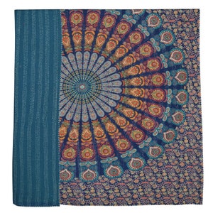 May include: A teal blue throw blanket with a large, colorful mandala design in the center. The mandala features a variety of colors, including orange, red, yellow, green, and blue. The blanket is made of a soft, comfortable fabric and is perfect for adding a touch of bohemian style to any room.