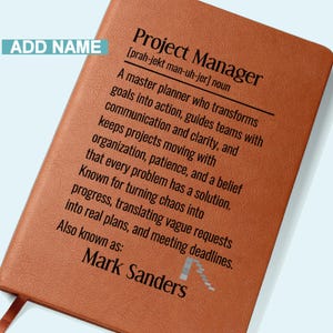 May include: A brown leather-bound notebook with the text "Project Manager" and a definition. The notebook includes the name "Mark Sanders" and the words "Add Name" in a light blue box.