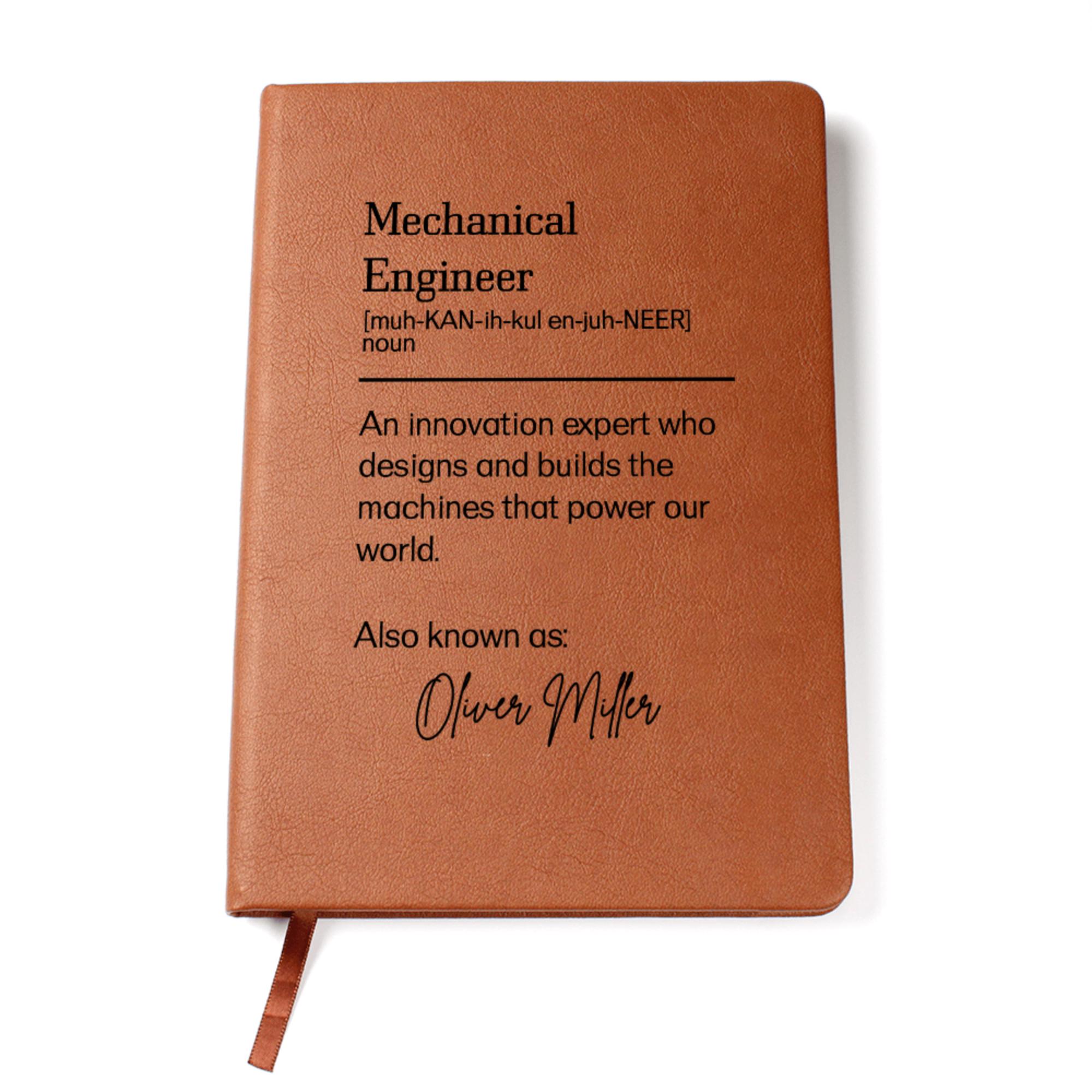 May include: A brown leather-bound journal with the definition of a mechanical engineer printed on the front. The definition includes the pronunciation and a description of the role. The journal is personalized with the name "Oliver Miller" printed below the definition.