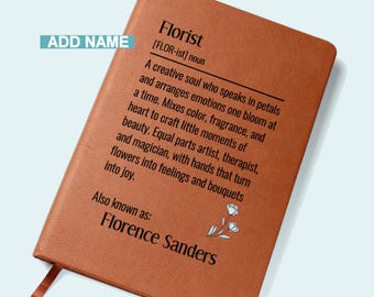 May include: A brown leather-bound notebook with the word "Florist" and its definition printed in black. The text describes a florist as a creative soul. The name "Florence Sanders" is also printed on the notebook.