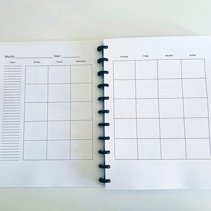 May include: A white planner with a black coil binding. The left page has a section for notes and a monthly calendar grid. The right page has a weekly calendar grid with days of the week labeled: Thursday, Friday, Saturday, Sunday.