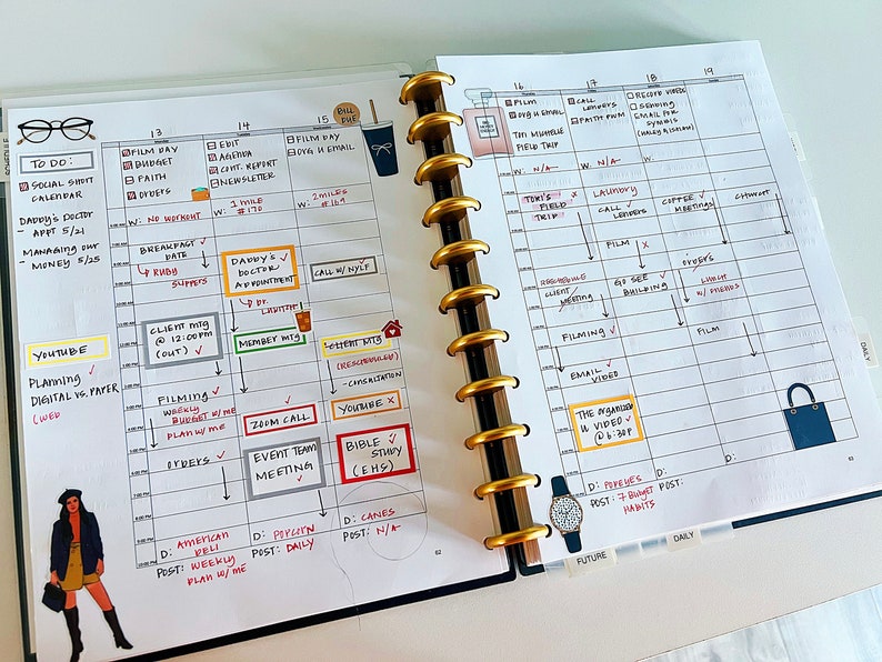May include: A weekly planner with a black and gold binding. The planner is open to a page with a daily schedule for the week. The planner has a to-do list, a YouTube planning section, and a section for daily posts. The planner is decorated with stickers and drawings.