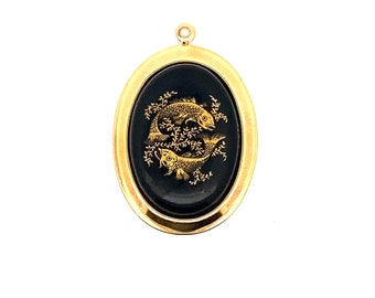 May include: Gold oval pendant with a black background and a gold image of two fish.