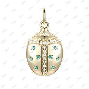 May include: A gold-tone charm in the shape of a ladybug with green and white accents. The charm is adorned with small, clear cubic zirconia stones.