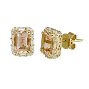 May include: A pair of gold earrings with a light pink gemstone surrounded by a halo of smaller diamonds. The earrings have a post back.