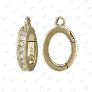 May include: Two gold-tone metal clasps with a single row of clear cubic zirconia stones around the perimeter of one clasp. The clasp on the right has a spring-loaded closure. Both clasps are marked "14K".