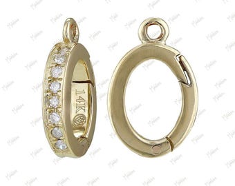 May include: Two gold-tone metal clasps with a single row of clear cubic zirconia stones around the perimeter of one clasp. The clasp on the right has a spring-loaded closure. Both clasps are marked "14K".