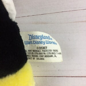 May include: Black and yellow plush bee toy with a white wing. The tag reads "Disneyland Walt Disney World &copy;DISNEY All New Materials Polyester Fibres 1525:PA 1378:OHIO PA 1378:MASS T-616 MASA TRADING CORP. BURBANK, CA, PRODUCT OF SRILANKA"