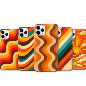 May include: Five smartphone cases featuring colourful designs. Three cases display vertical wavy lines in shades of orange, red, brown, and teal. One case features diagonal stripes in similar colours, and one case depicts a sun rising over clouds.