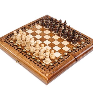 May include: A wooden chess set with a decorative border. The chessboard is square, with light and dark squares, and is populated with chess pieces in light and dark wood tones. The set is on a white background.