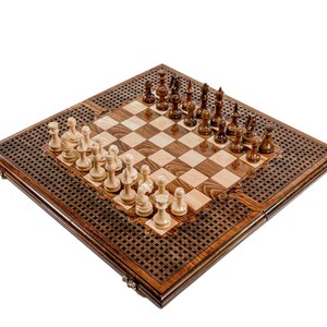 May include: A wooden chess set with a dark brown border and a light brown and dark brown checkered playing surface. The chess pieces are arranged on the board, with light-colored pieces on one side and dark-colored pieces on the other. The set is on a white background.