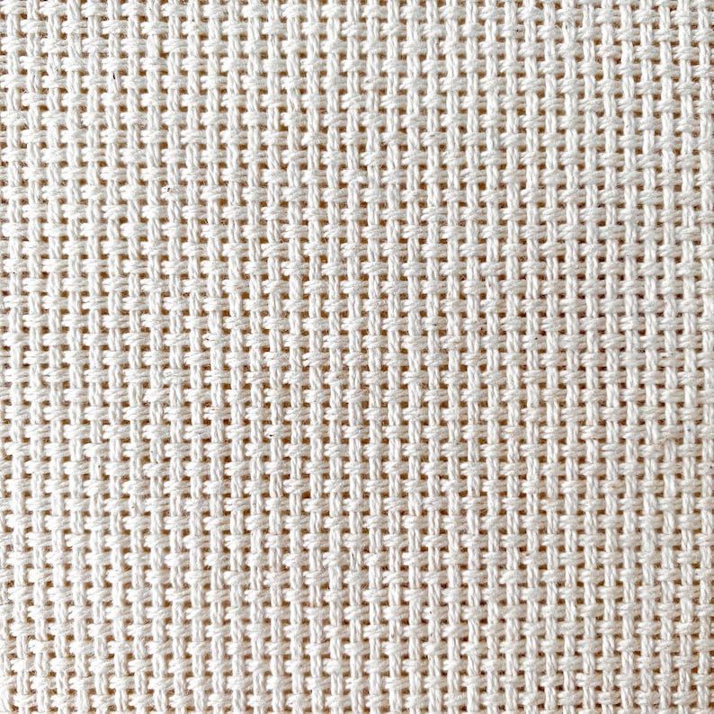 May include: Close-up of a white woven fabric with a grid pattern.