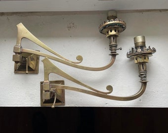 A pair of 19th century swivel arm brass gas wall lights with glass shades