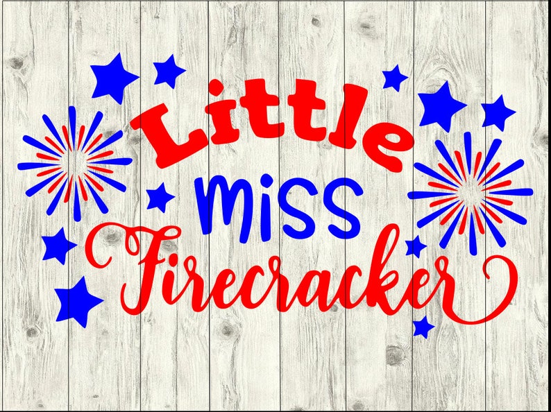 May include: Red and blue text on a white wood background reads "Little miss firecracker". The text is surrounded by red and blue fireworks and stars.