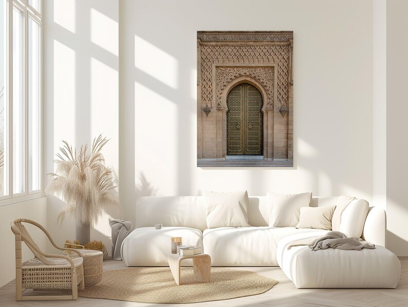 Puede incluir: Impresi&oacute;n enmarcada de una puerta arqueada ornamentada con un dise&ntilde;o tallado detallado. La puerta es dorada y el marco es de color marr&oacute;n claro. La impresi&oacute;n cuelga sobre un sof&aacute; seccional blanco en un sal&oacute;n moderno y luminoso.