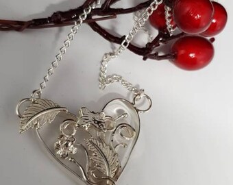 Handmade sterling silver filigree necklace features a heart filled with beautiful summer accent ie butterfly,  flowers, leaves, vines..