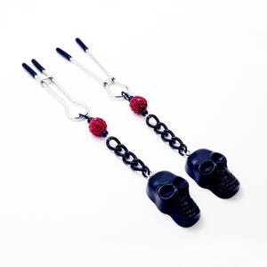 Gothic Nipple Clamps for Halloween. Straight Tweezer Clamps with Black Skulls. MATURE