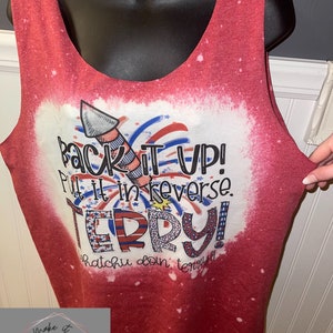 May include: Red sleeveless tank top with a white bleached design. The design features a firework, the text "Back it up! Put it in reverse. Terry! Whatchu doin' terry!"