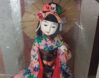 oriental dolls in glass cases