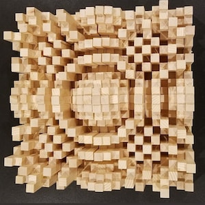 May include: A 35-inch by 35-inch wooden acoustic panel made of small, square blocks. The blocks are arranged in a pattern that creates a wave-like effect. The panel is light brown in color.
