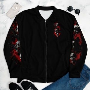 May include: Black bomber jacket with a red and white skull and guitar design. The jacket has a zipper closure and two pockets.