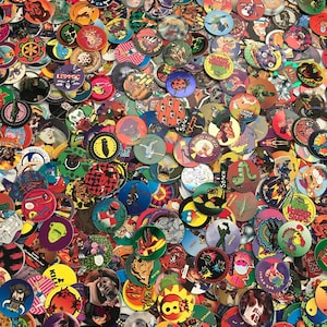 May include: A large collection of colorful plastic game tokens featuring various cartoon characters and designs. The tokens are round and have a variety of themes, including animals, sports, and pop culture.